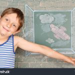 stock-photo-flight-of-fantasy-schoolboy-before-chalkboard-with-drawing-of-airplane-back-of-open-window-210832423